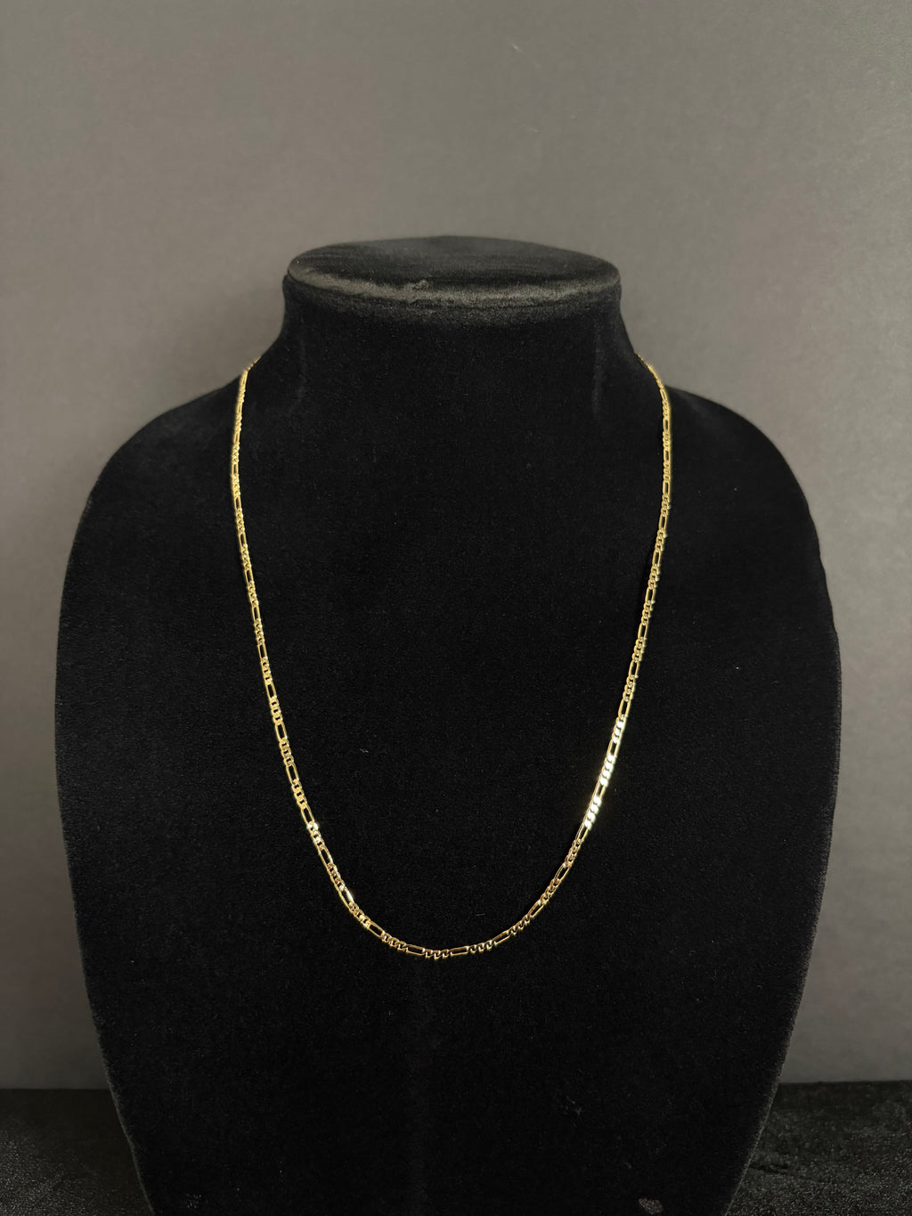2.4 mm Mini Figaro chain, 22 inches — front view on a black display