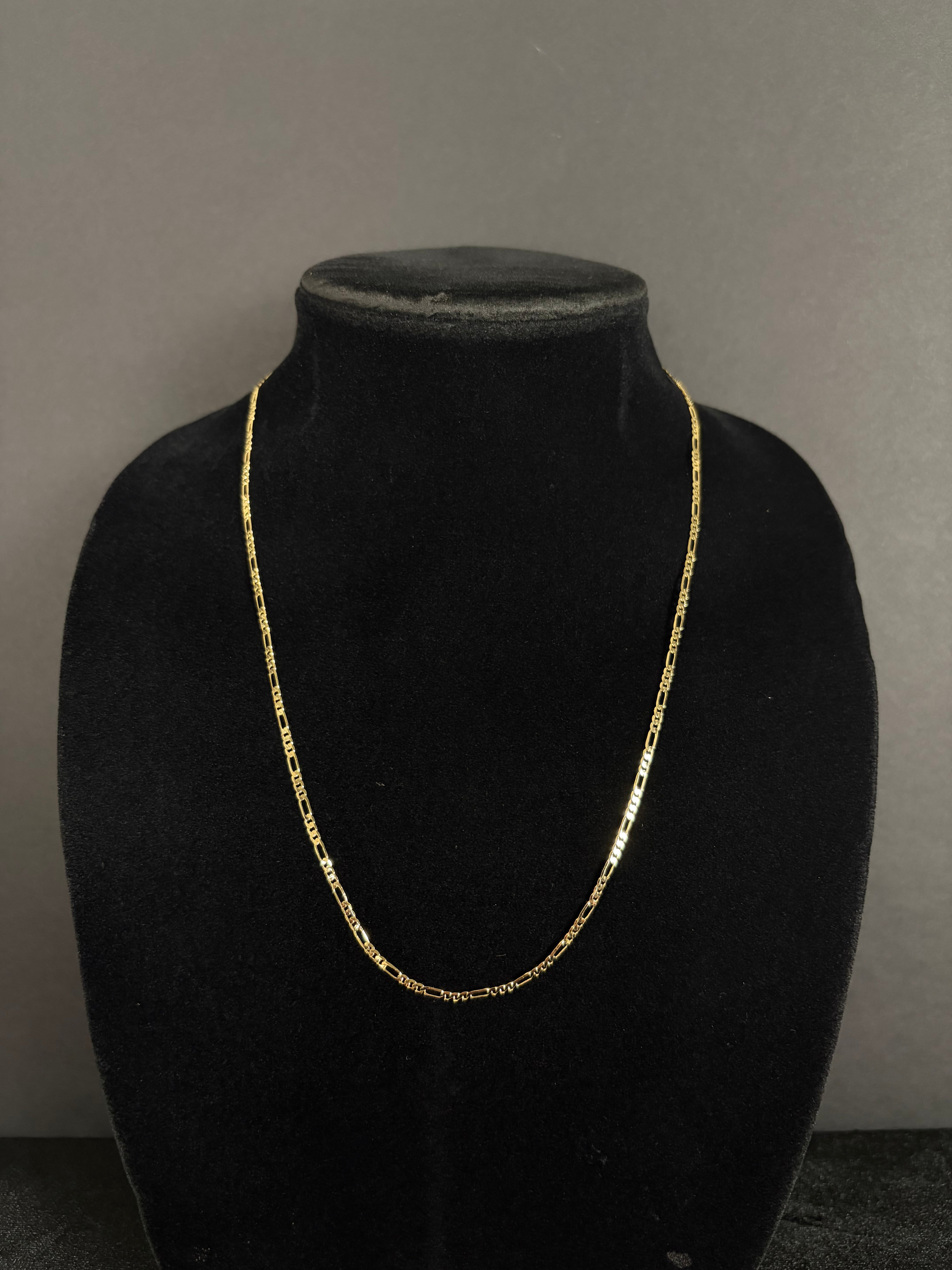 2.4 mm Mini Figaro chain, 22 inches — front view on a black display