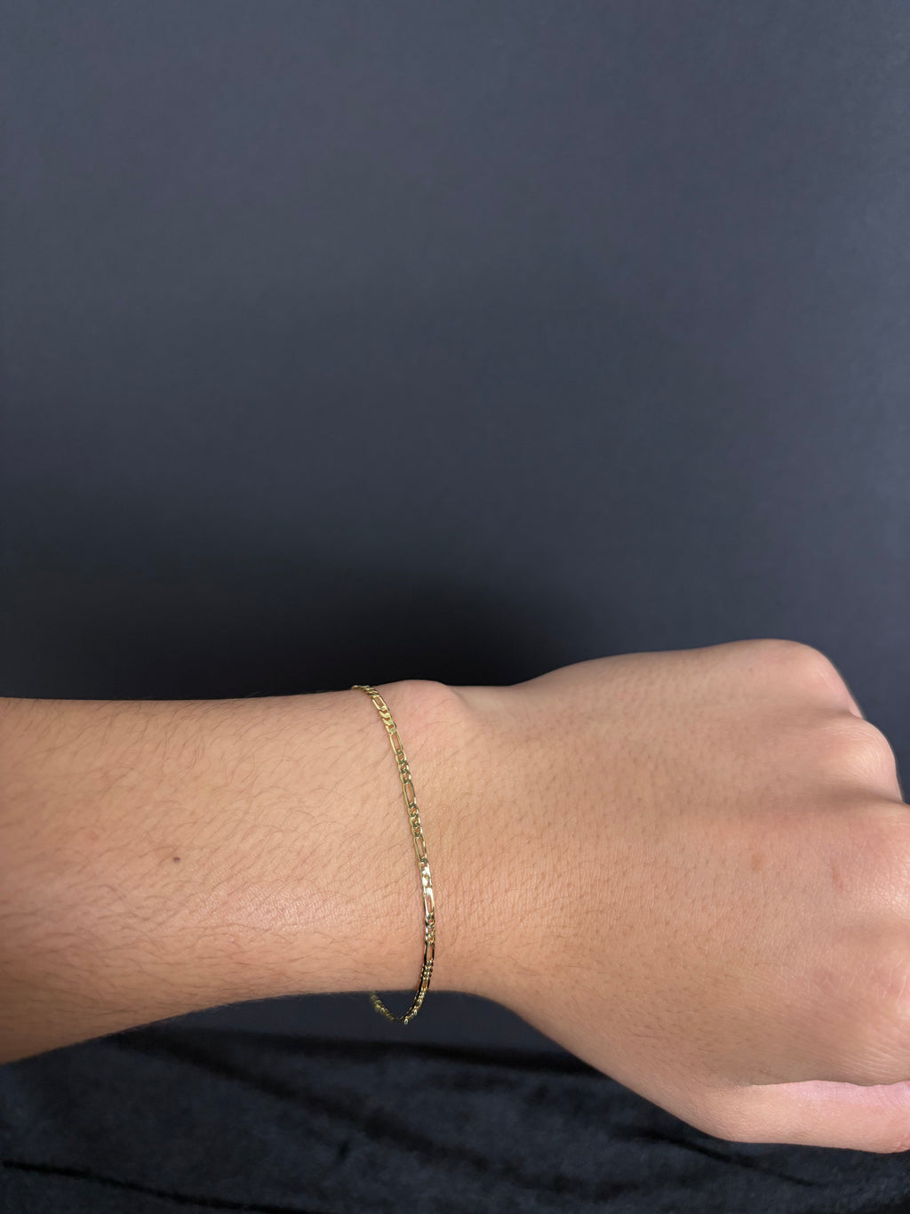 2.4 mm Mini Figaro bracelet, 8 inches — worn on a wrist