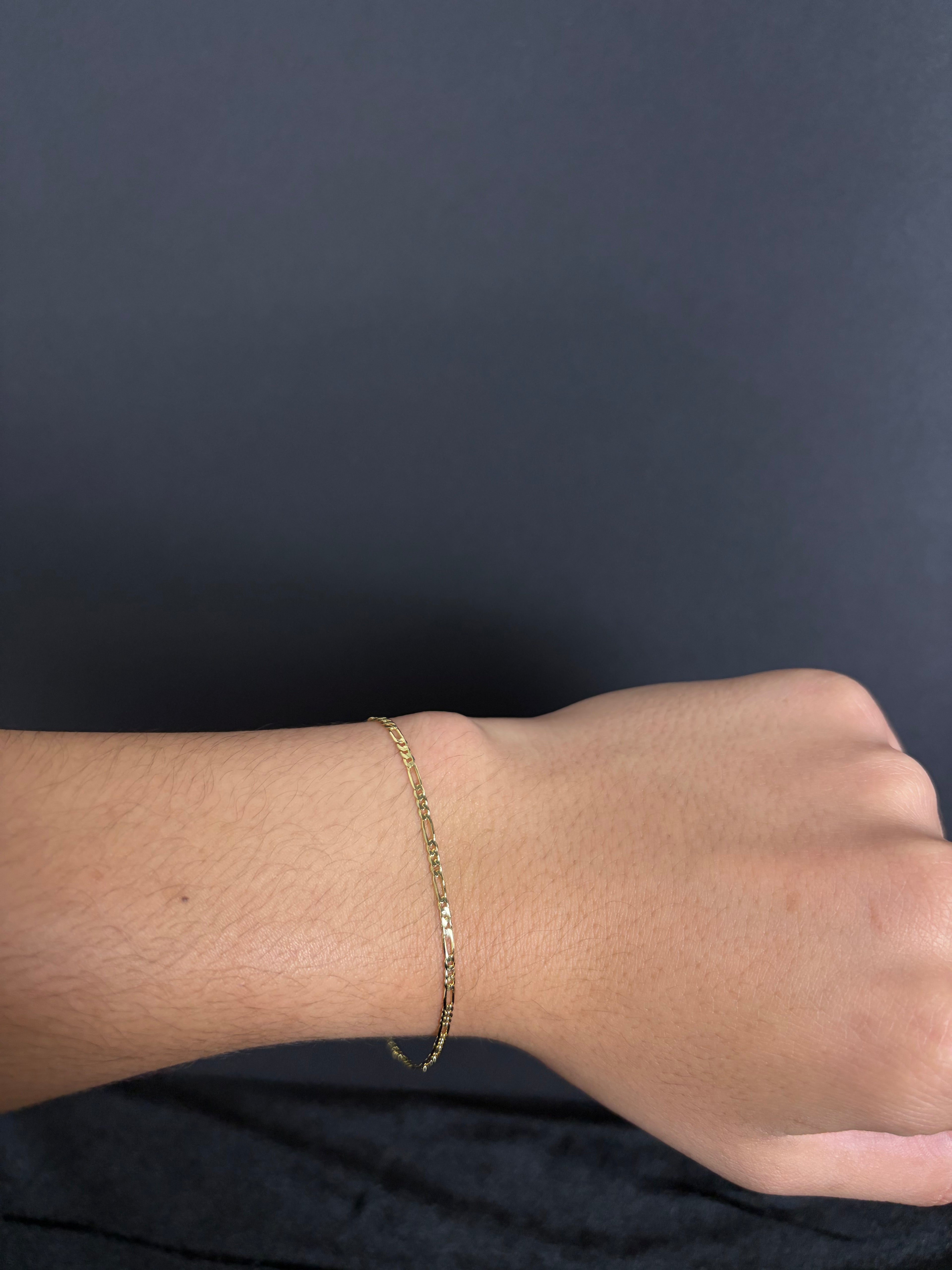 2.4 mm Mini Figaro bracelet, 8 inches — worn on a wrist