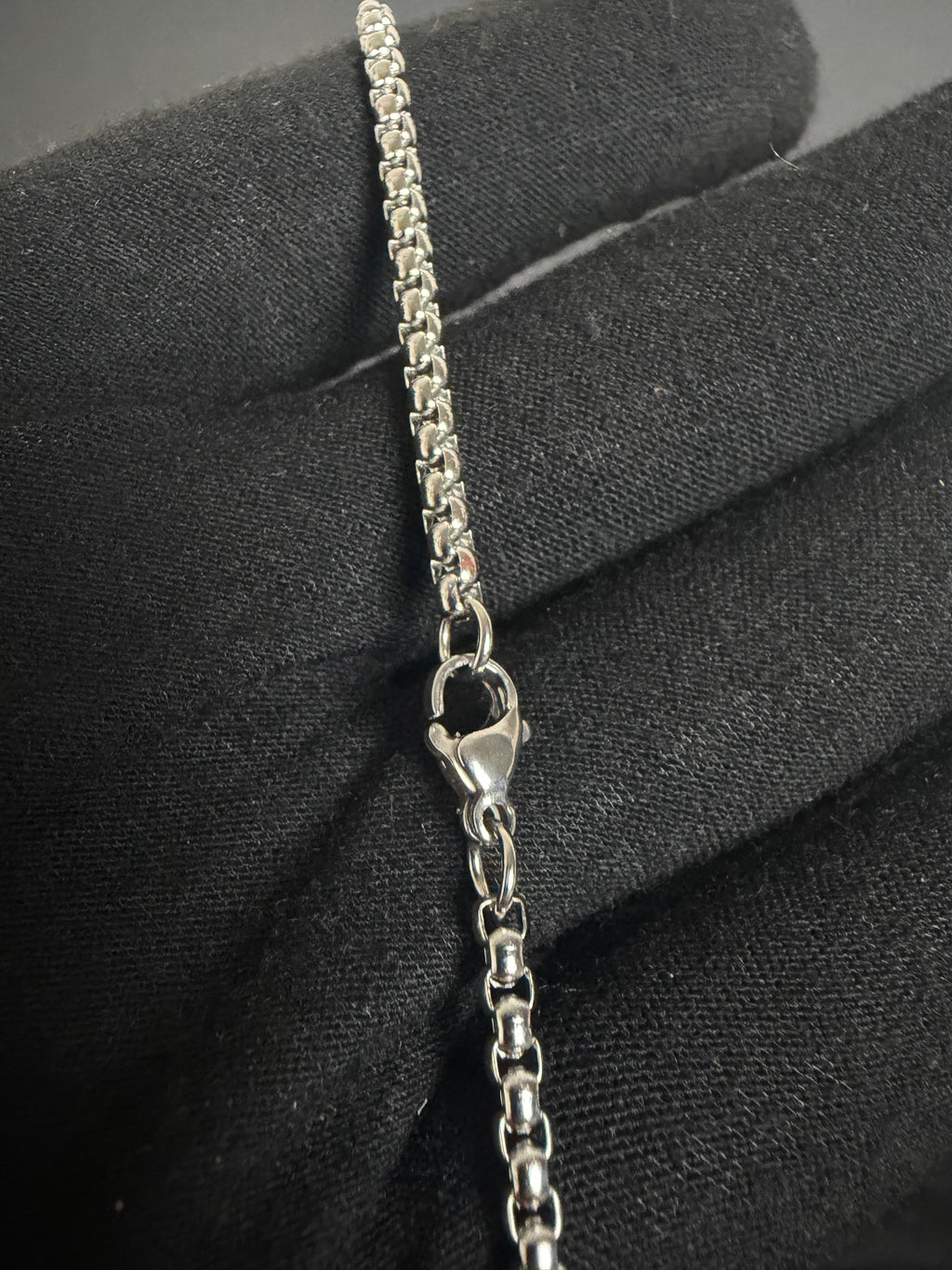 Silver-tone cross necklace — chain and clasp detail