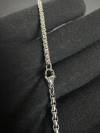 Silver-tone cross necklace — chain and clasp detail